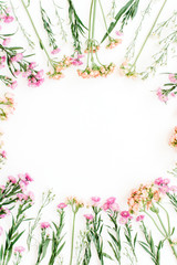 Plakat Round frame of colorful wildflowers, green leaves, branches on white background. Flat lay, top view. Valentine's background