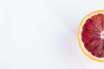 Single half of a blood orange isolated on white