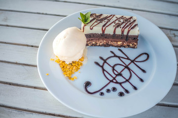 Two tone cake with ice cream on the dish