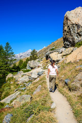 Fototapeta premium Grindjisee - hiker in beautiful landscape of lake at Matterhorn at Zermatt, Switzerland
