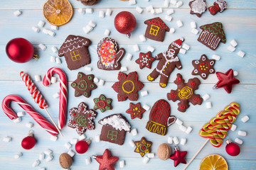 Christmas homemade gingerbread cookies, sweets and Christmas decor on wooden table

