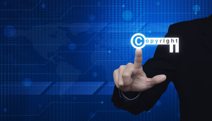 Businessman pressing copyright key icon over digital world map technology style, Elements of this image furnished by NASA