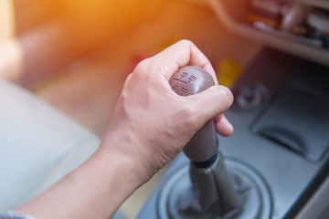 Hands of a driver shifting the gear on car manual gearbox