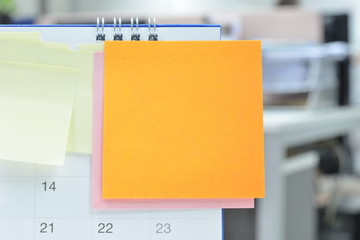 Paper notes on calendar at business office with copy space for text,office supplies