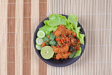 Spicy sour fried chicken salad call Yum Kai Zap - Thai.
