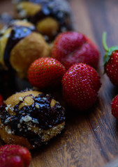 freshly picked ripe strawberries and homemade cookies served on a wooden plate