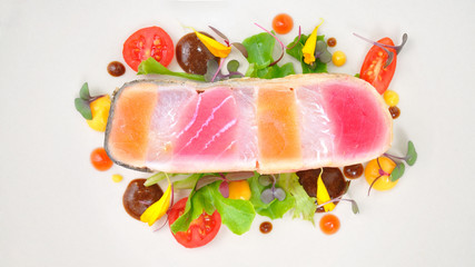 Raw fish steak design lay on white plate.