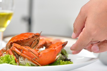 Food stylist setting up Salad boiled sea crab with green salad f