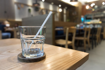 Empty glass with straw on the table.
