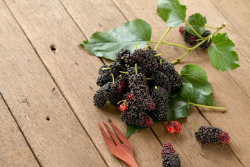 Mulberry is healthy fruit for make juice put on wooden desk back