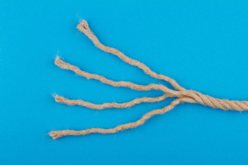 close up of unraveled rope on blue background