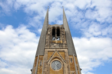 St John Church in Wurzburg. Tower in double spire in the Neogothic style. Look up. Germany