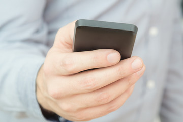 Urban guy / businessman with a cellphone. Shallow depth of field.
