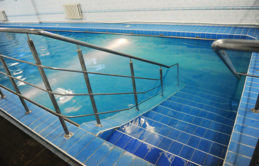 Descend the stairs in a blue pool