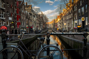 Beautiful sunset over Amsterdam, The Netherlands, with bicycles on the bridge in winter