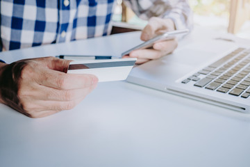 Fototapeta premium Businessman hand using smart phone and credit card for shopping online.Online shopping concept.