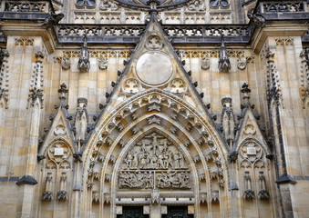 Detail of the main entrance of the Gothic Church of St. Vitus in Prague. Fronton decorated with religious sculpture made of stone.