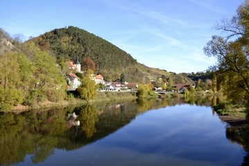 Fototapeta na wymiar River with water reflections and houses 