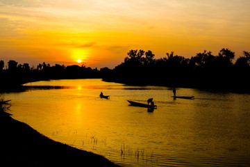 fisherman silhouette at moonnoi in thailand