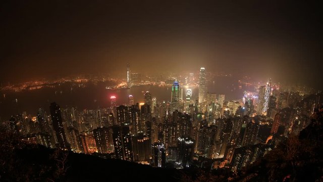 Wide angle time lapse of Hong Kong Island. With landmark skyscrapers and their glowing colorful lights at night