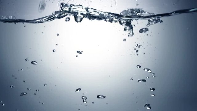 Slo-motion cubes falling through water. 120 fps.
