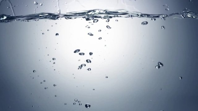 Slo-motion cubes falling through water. 120 fps.