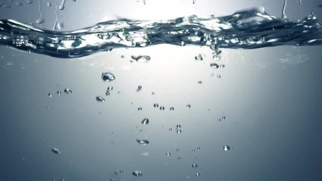 Slo-motion cubes falling through water. 120 fps.