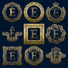 Vintage monograms set of E letter. Golden heraldic logos in wreaths, round and square frames.