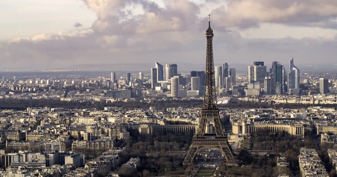 Aerial panning time lapse view of the Eiffel tower and the financial district of La Defense in Paris