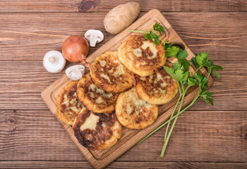 Potato cakes stuffed with mashrooms.