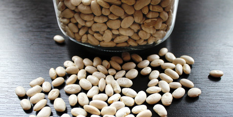 White beans grains in a glass jar on the table
