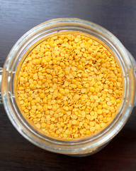 Yellow lentils in a glass on a table in the kitchen
