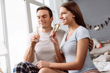 Joyful young couple drinking champagne