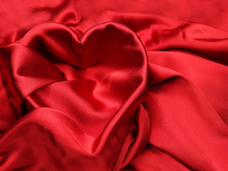 Obraz premium red satin material with heart shape love concept