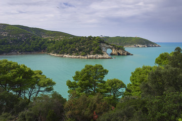 Fototapeta premium Apulia coast: panoramic view of San Felice Bay, Italy.Gargano National Park: the little rock arch (Architello) is spectacular symbol of Vieste town.