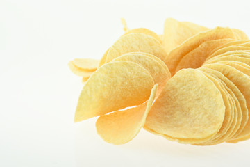 Fototapeta na wymiar Multiple yellow potato chips snacks, composition isolated over t