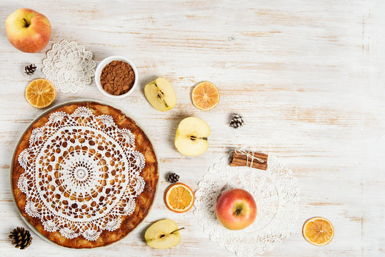 Apples, spices  and apple pie on rustic, vintage, wooden background with copy space. top view