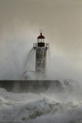 Fototapeta na wymiar Old lighthouse covered by stormy waves