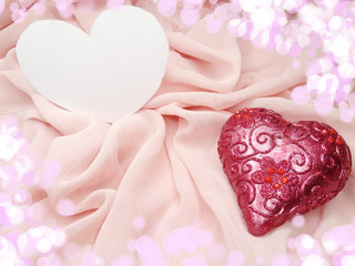 red satin material with heart shape love concept