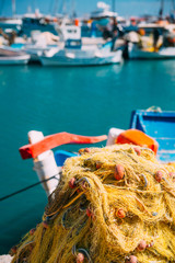 Cycladic greek fishing boat and nets in a pier on Santorini, Greece - 132306337