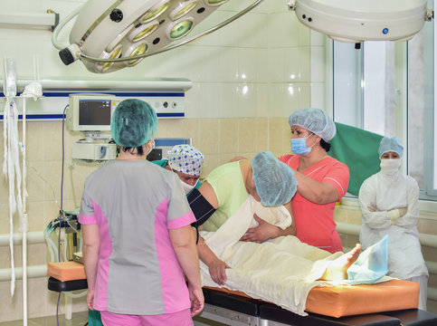 Preparation for euthanasia/The doctor is a specialist in the field of euthanasia and three nurses are preparing the patient to sleep before a difficult operation.