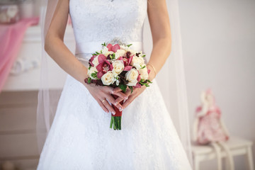 Obraz na płótnie Canvas White roses in hands of the bride