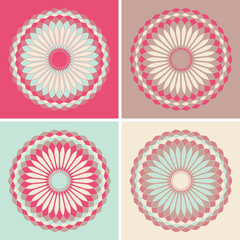 four rosettes of circular flowers in blue and pink shades