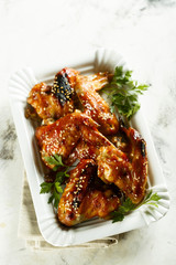 Chicken wings in maple syrup glaze with sesame seeds