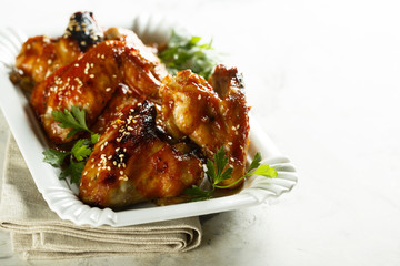 Chicken wings in maple syrup glaze with sesame seeds