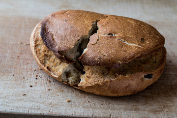 Ciabatta Bread split in two pieces on wooden surface