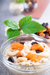 One portion of oatmeal with fruit and berries in a glass