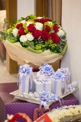 A bouquet of flowers, white and red rose with chocolate gift box, vertical