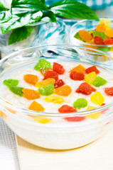 Oatmeal with colorful candied fruits in a glass bowl
