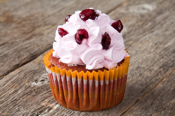 Cupcake with cream frosting and berries